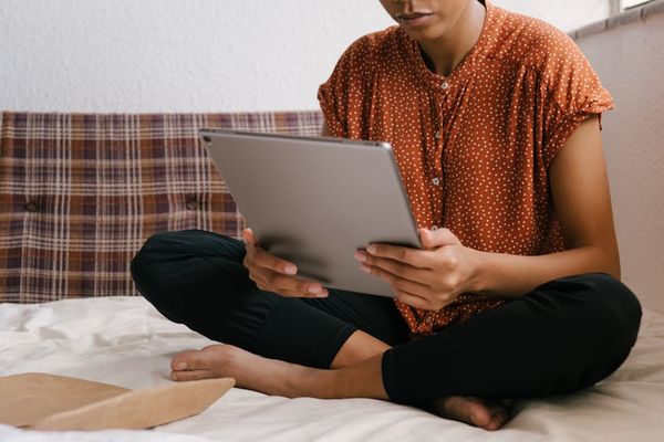 A person sitting comfortably in a well-lit home office with good posture.